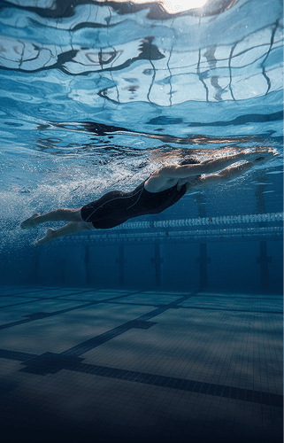 Swimmers in an indoor pool lane